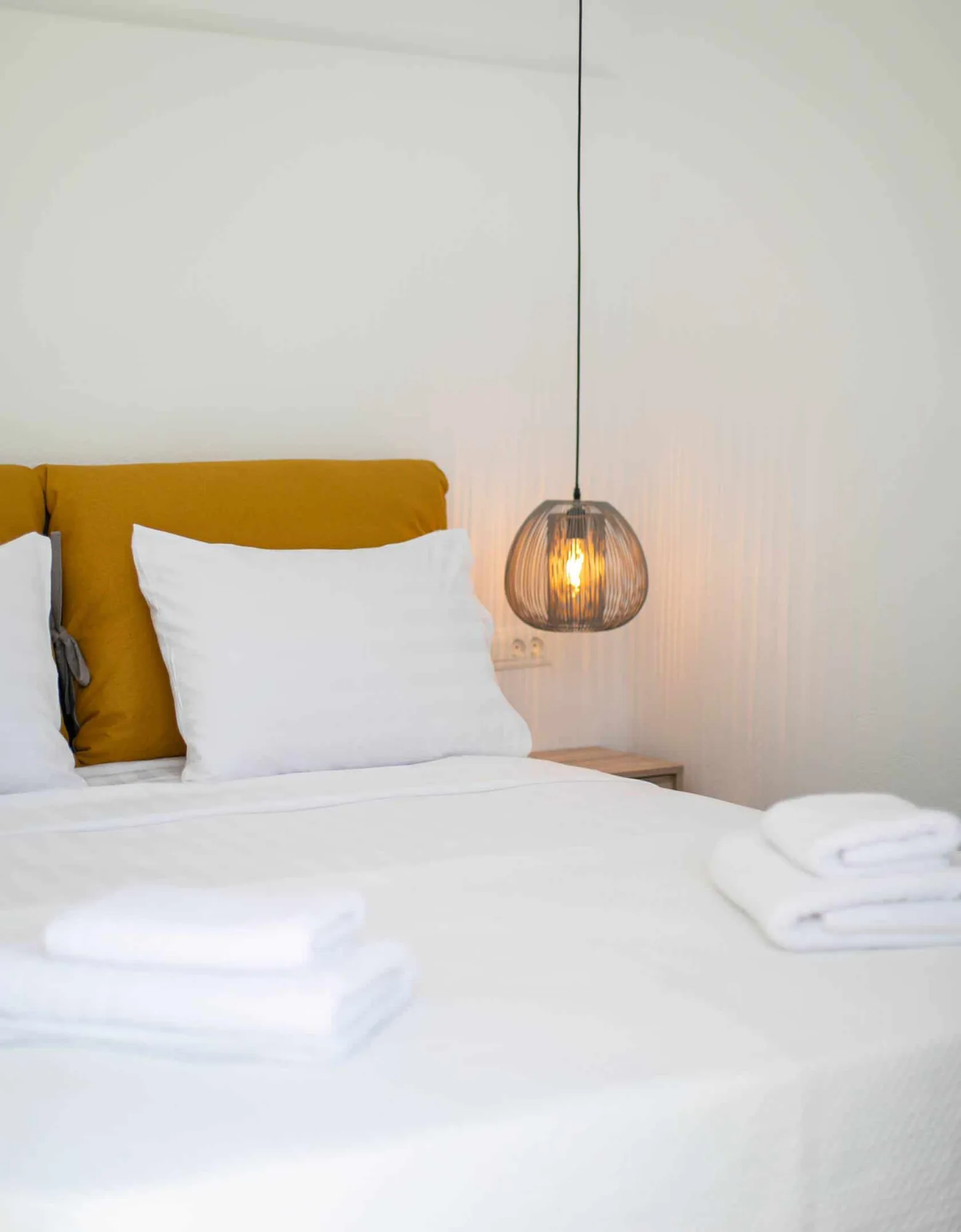 Ochre cushion and pendant lamp detail